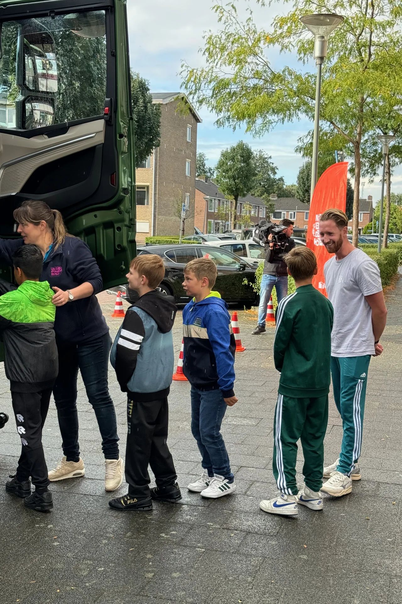 Pupils practise with instructors beside the open truck cab